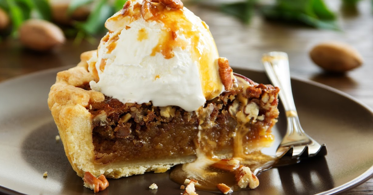 a slice of pecan pie with ice cream and maple syrup on top