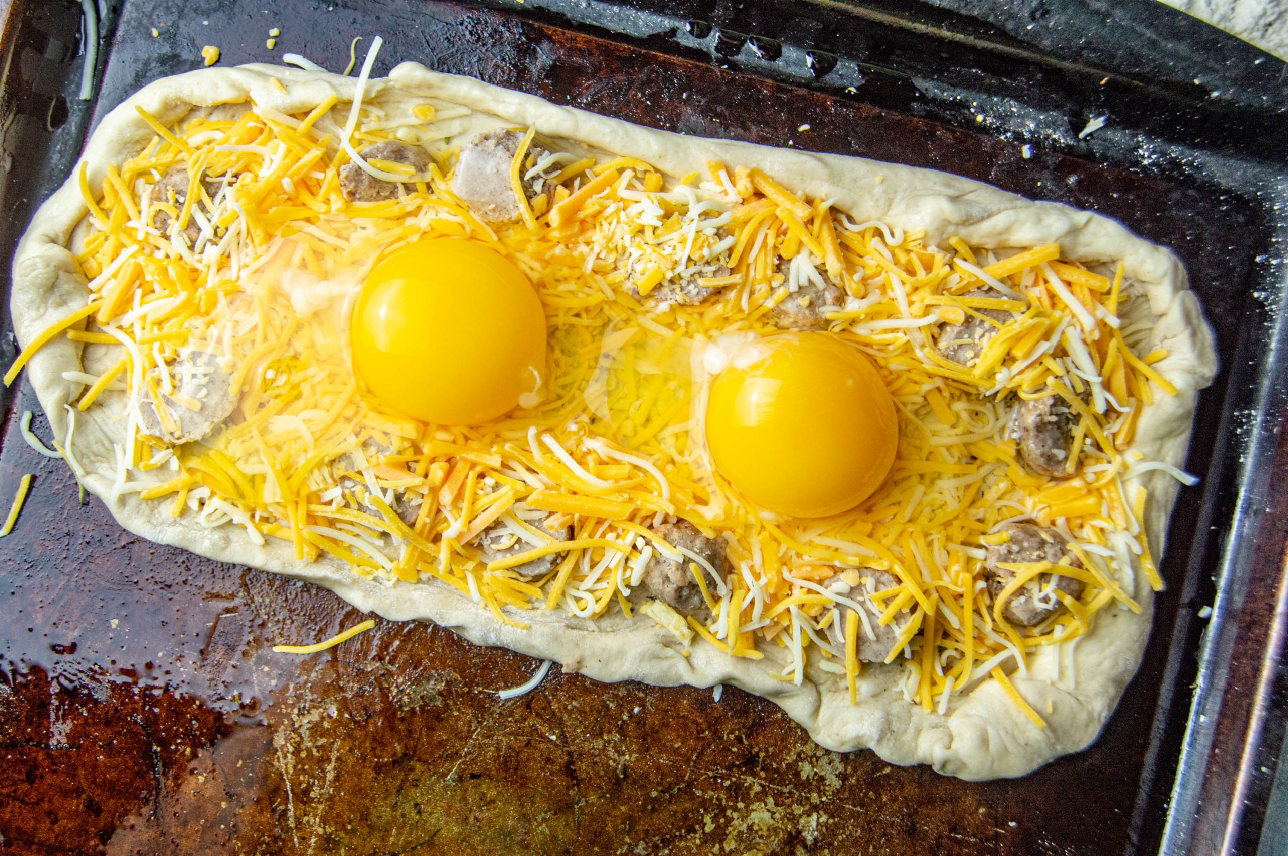 breakfast pizza nearly ready to go in the oven