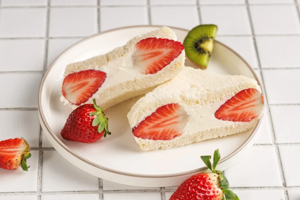 Japanese fruit sandwich halves arranged neatly on a plate for serving.