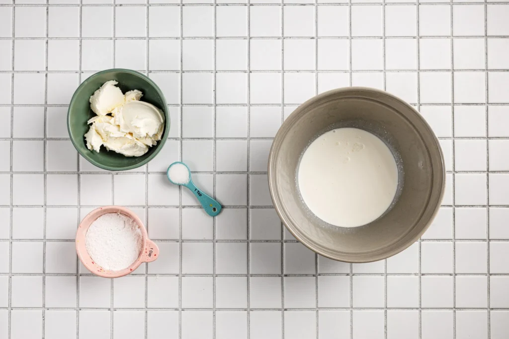 Ingredients for Japanese Fruit Sando including heavy cream, sugar, and mascarpone on a tiled surface.