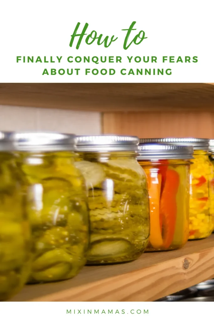 Assorted jars of canned pickles, peppers, and corn neatly arranged on a pantry shelf.