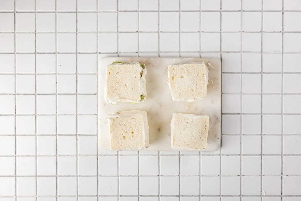 Four assembled Japanese fruit sandwiches wrapped and ready to chill before serving.