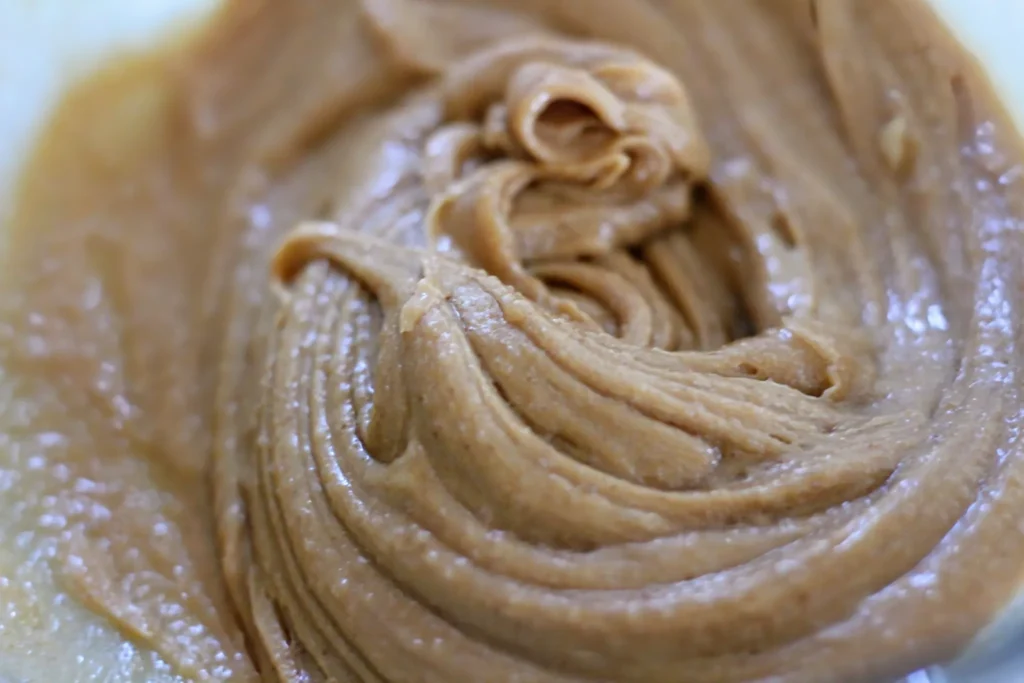 Powdered sugar added to the peanut butter mixture, ready to be combined.