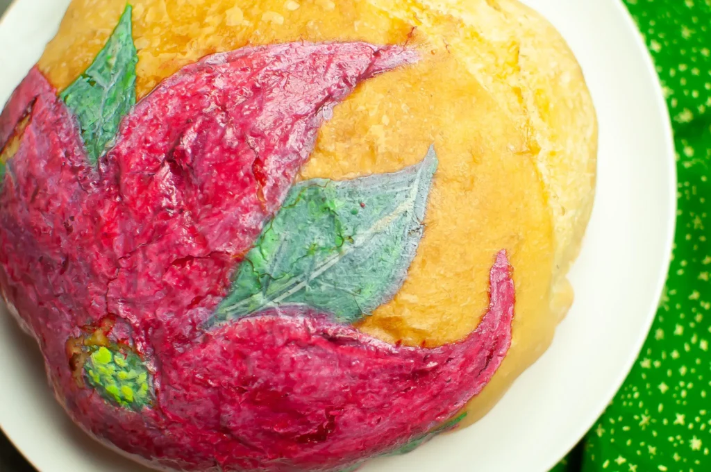 Close-up of the baked poinsettia design, showing brush texture and details in petals and center.