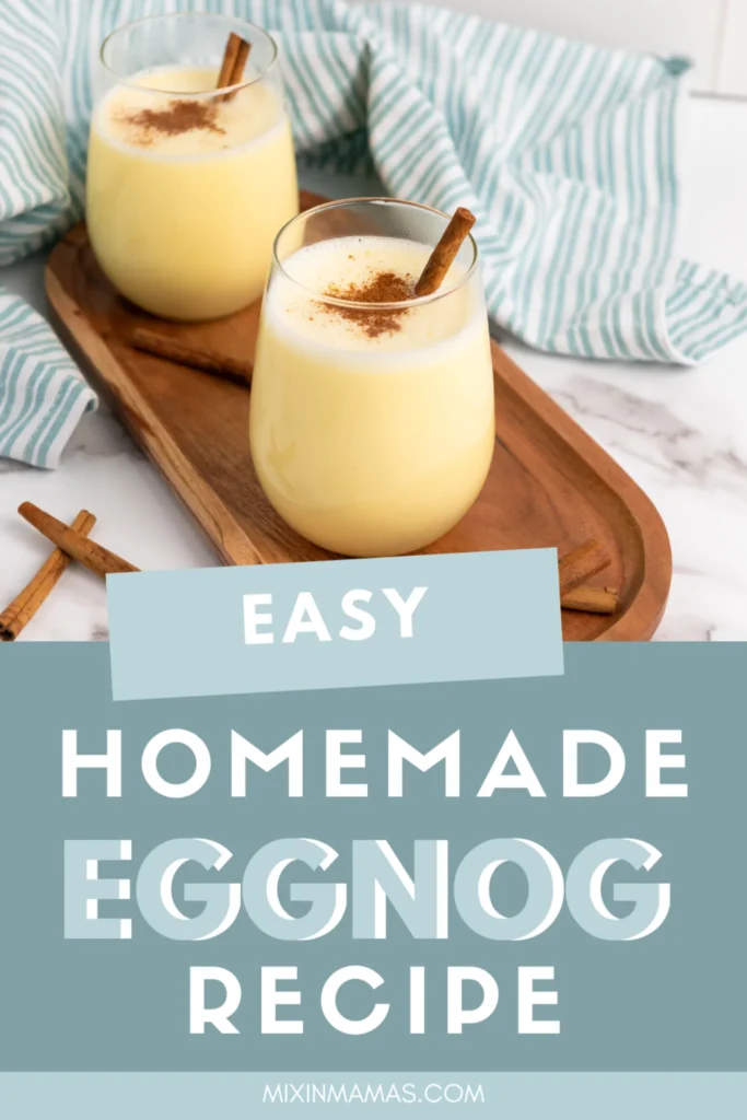 Two glasses of homemade eggnog garnished with cinnamon sticks on a wooden tray