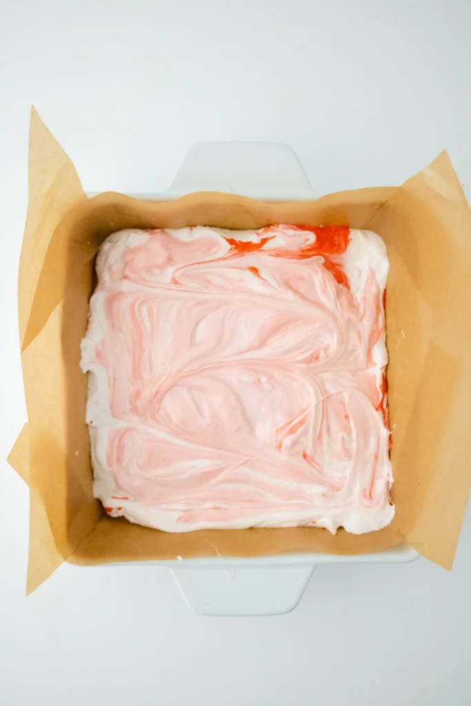 Red and white marbled peppermint marshmallows in pan
