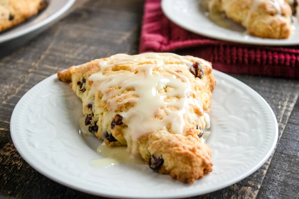Bakery-style orange cranberry scones served on plates