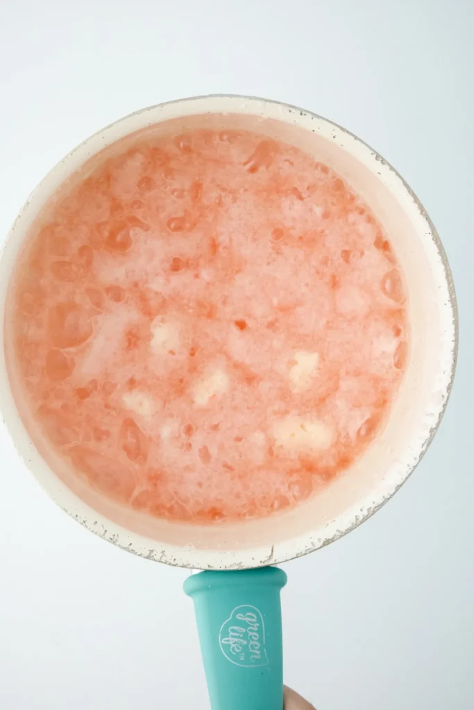 Candy cane pieces melting in sugar syrup for peppermint marshmallows