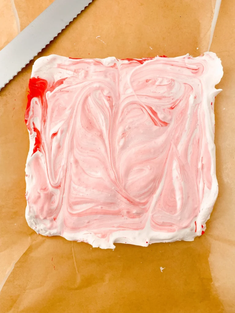 Peppermint marshmallows fully set in parchment-lined pan