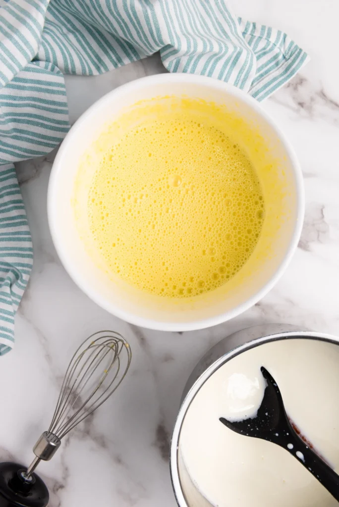 Tempering egg yolks with warm milk while making homemade eggnog
