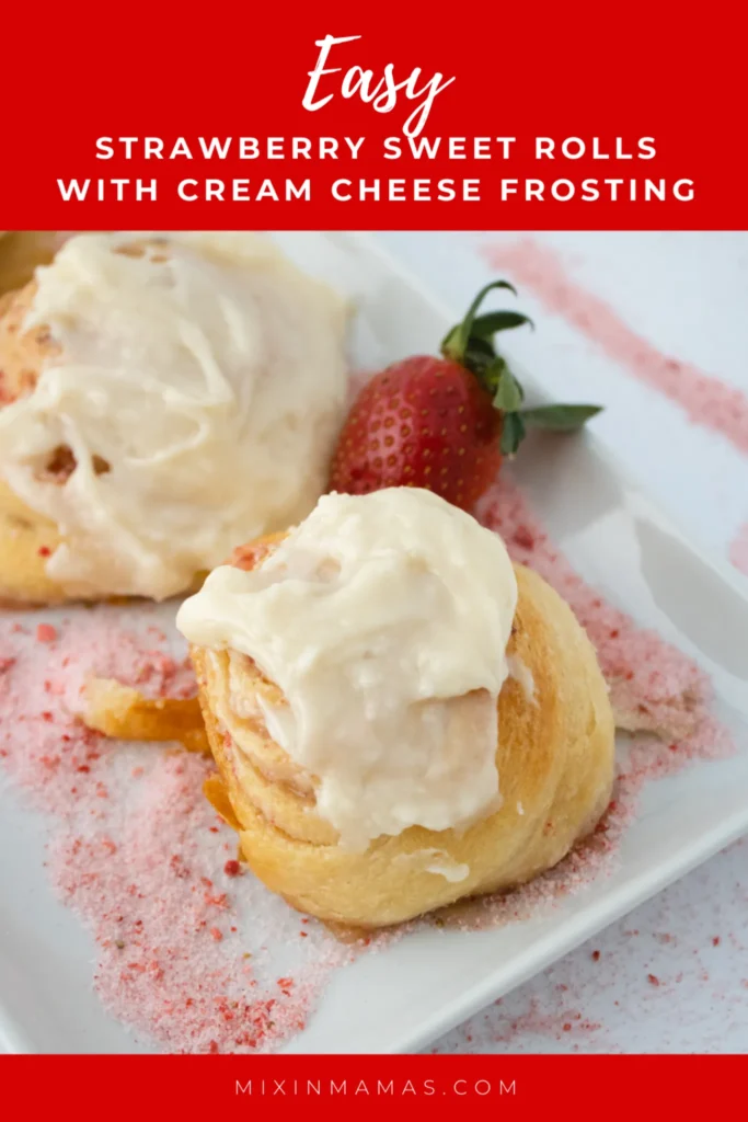 Close up of strawberry sweet rolls with cream cheese frosting and fresh strawberries