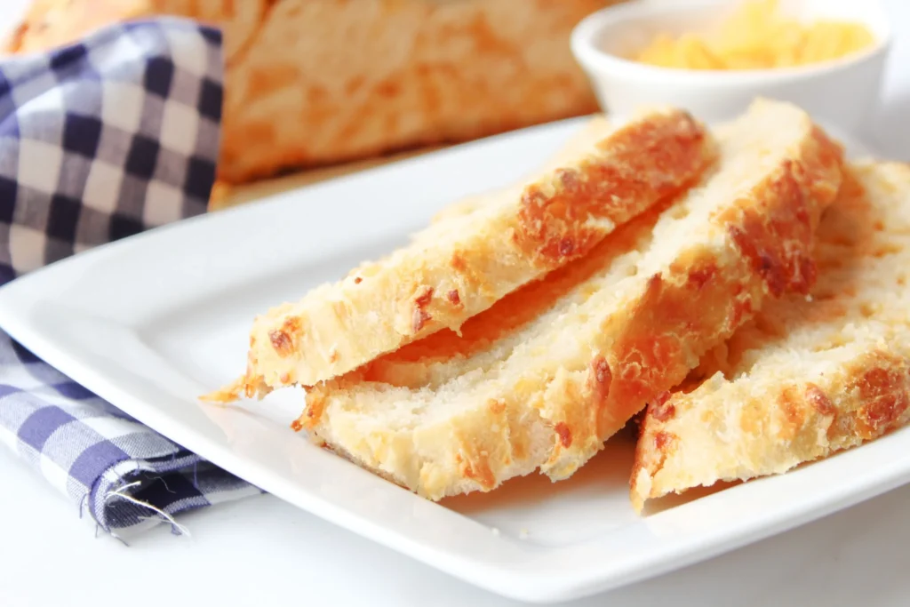Sliced cheddar artisan bread on a white plate