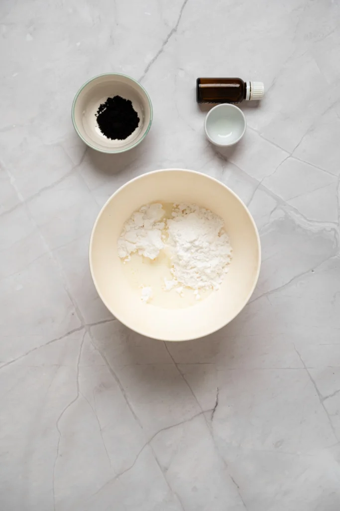 Powdered sugar and milk in a mixing bowl for making lavender cookie icing.