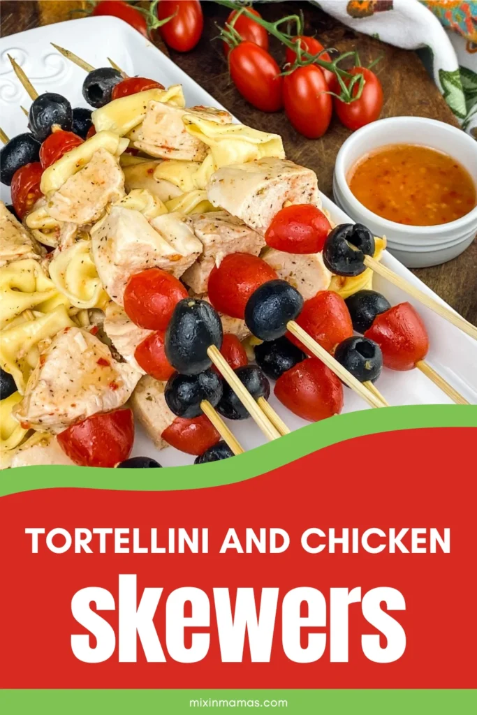 Pinterest graphic featuring tortellini and chicken skewers with tomatoes, black olives, and Italian dressing on a serving platter.
