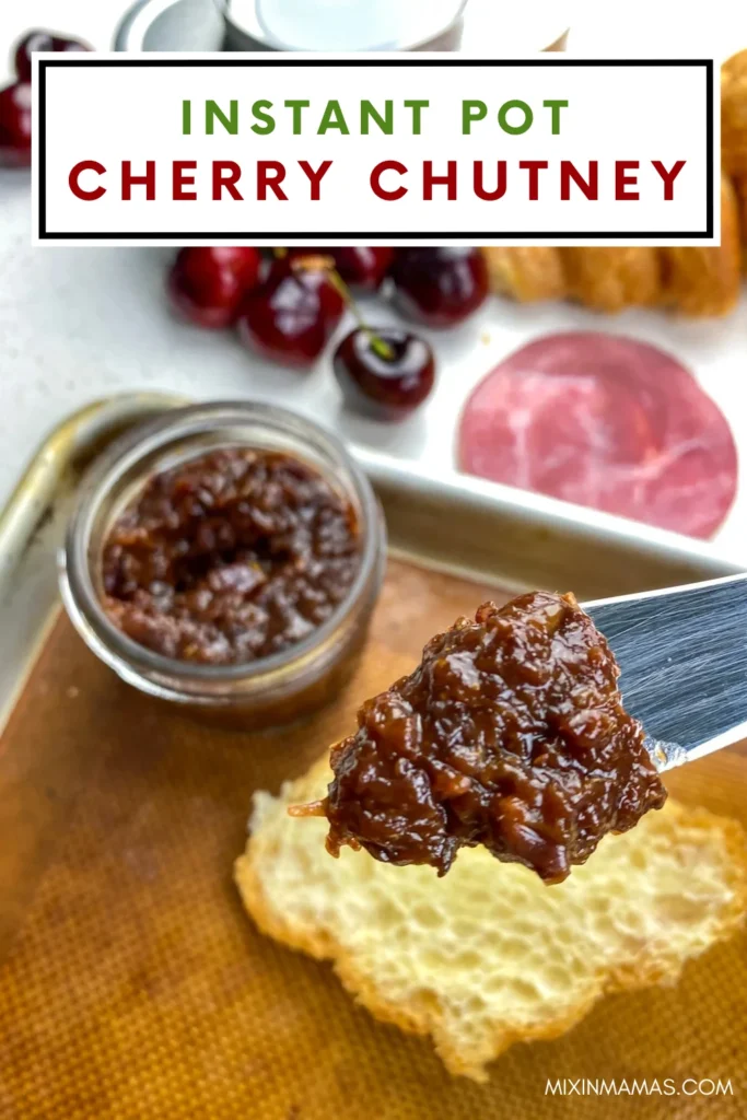 Close-up of homemade Instant Pot cherry chutney on a butter knife with toasted bread and appetizer ingredients nearby.
