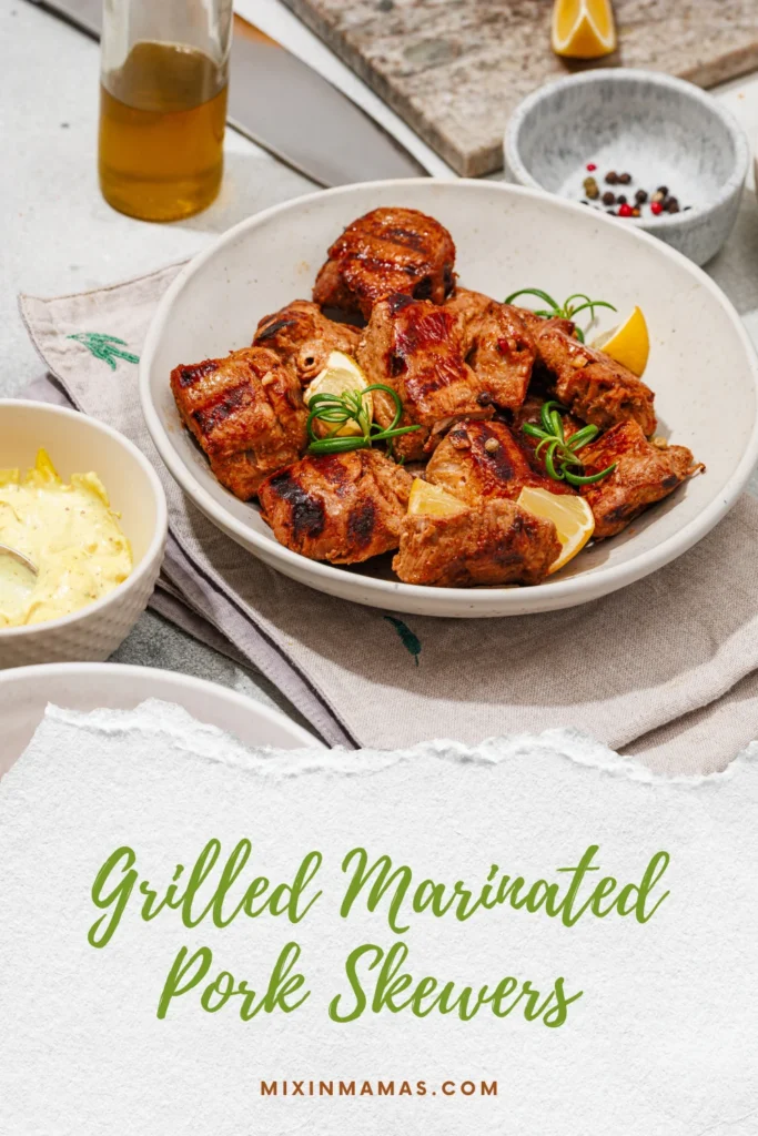 Grilled marinated pork with lemon and rosemary beside a bowl of homemade aioli.