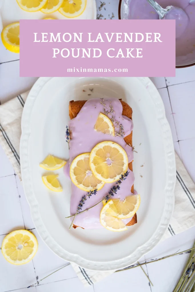 Lemon lavender pound cake topped with pale purple glaze, fresh lemon slices, and lavender sprigs on a white serving platter.