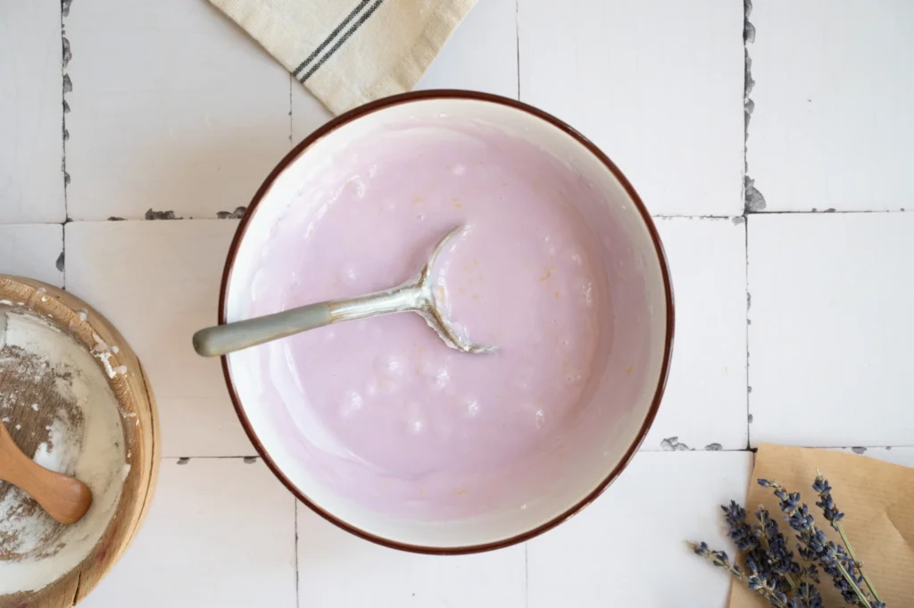 Pale purple lemon lavender glaze mixed and ready to drizzle over the pound cake.