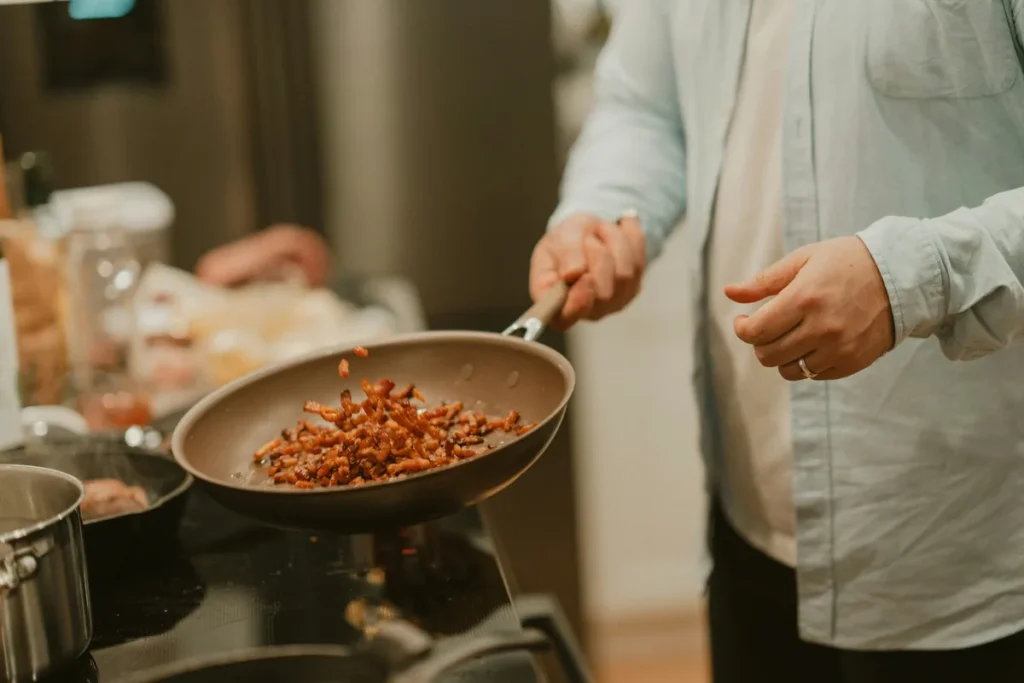 Cooking chopped nuts in a skillet on the stovetop