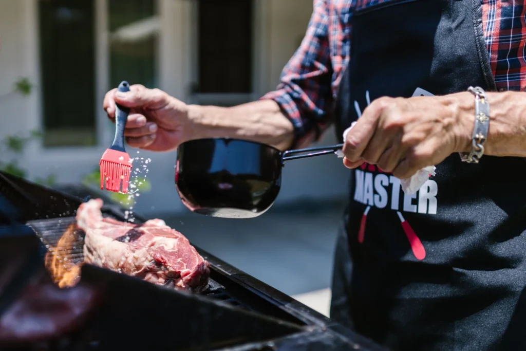 Marinated steak cooking on an outdoor grill